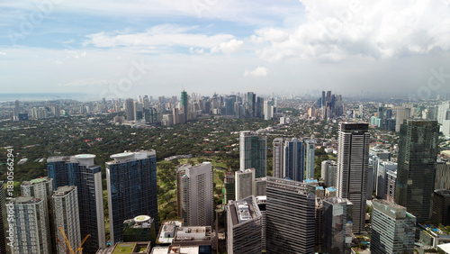 Aerial panorama of Bonifacio Global City business district in Taguig with skyline view of Makati City, Metro Manila, Philippines