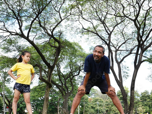 Father and Daughter Taking a Break During Outdoor Exercise in Park