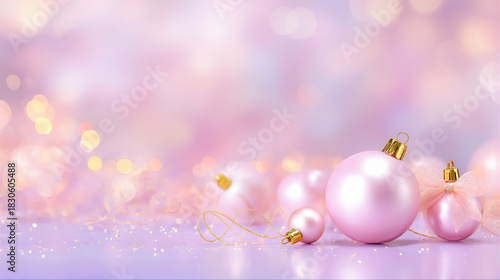 パステルピンクの背景に輝くクリスマスオーナメントと幻想的なボケ