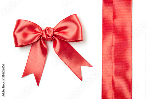 Bright red satin ribbon bow and matching ribbon strip isolated on white background