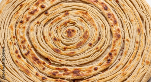 Perfectly crafted concentric circles of flaky paratha bread golden and subtly toasted