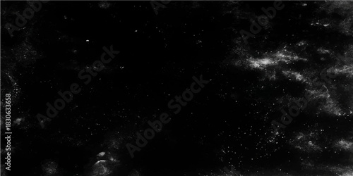 Abstract grunge background of cosmic dust particles glowing in the dark night sky