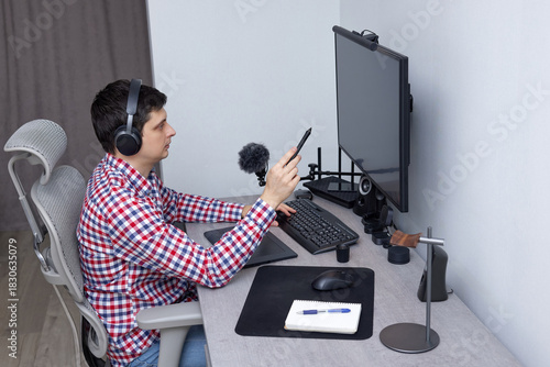 Man pointing stylus at computer screen, working from home