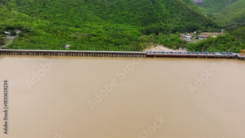 Aerial Tilt Down from Utility Vehicles on Dam Road to Rushing Spillway Gates