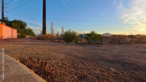 Wallpaper Mural Low angle rising shot starts at ground level and slowly tilts up to reveal massive industrial towers, smokestacks, and refinery structures against a dramatic sky. Torontodigital.ca
