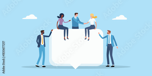 Diverse business team collaborating around a large speech bubble for communication and teamwork