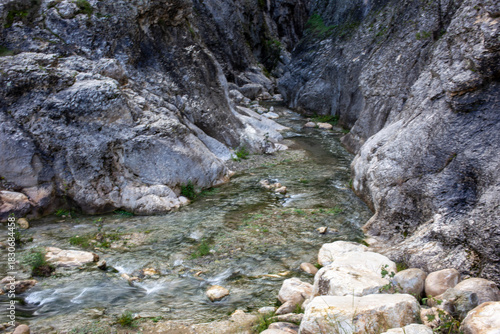 Rocky canyon stream flowing through narrow passage