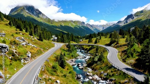 Aerial View Curving Mountain Road with River Valley and Alpine Scenery
