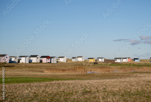 Fototapeta Naklejka Na Ścianę i Meble -  colorful beach huts in tall coastal grass on the Baltic Sea coast
