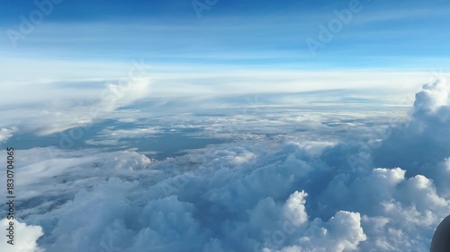 4K Scenic view of clouds in the sky as seen from a flight during a cloudy day in India. Scenic cloudy background. Layers of clouds visible from a flight during the monsoon season. POV of beautiful sky
