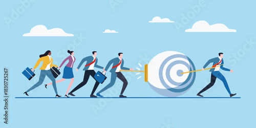 Business team pushing a large target towards a goal