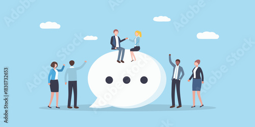 Diverse business people interacting around a large speech bubble with dots