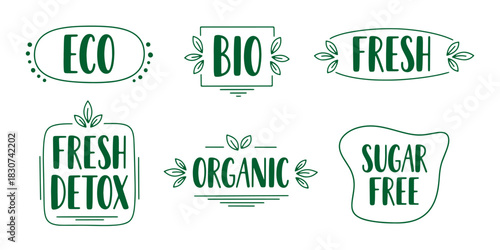 Set of hand-drawn green typographic labels promoting eco-friendly, organic, and bio products with leaf accents.
