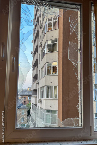 KYIV, UKRAINE - JUNE 6, 2025: Damage to the balcony of a residential building after a drone strike, showing broken windows and debris on the wall.