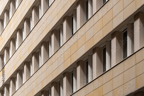 A modern architecture composition uniting facade repetition and pattern forms as geometry aligns with background tones and contrast to reinforce a structure guided by abstract design and urban texture