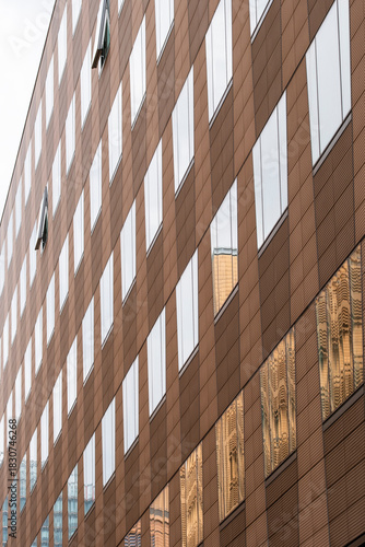 Minimal modern architecture presenting facade symmetry and pattern flow where geometry, background reflections and contrast articulate a structure shaped by abstract design and urban texture