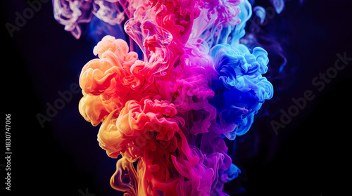 Bright pink, blue, and orange ink clouds swirling in water, photographed against a black background, concept of creativity and motion