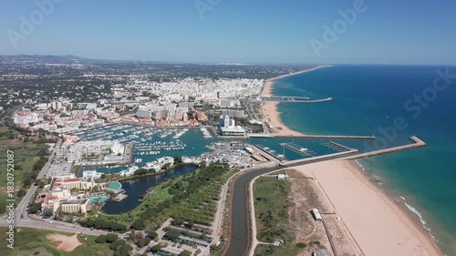 Wallpaper Mural Vilamoura aerial view aerial coastal view vilamoura resort and marina stretch with long sandy coastline, protective jetties, blue ocean, resort buildings and winding waterfront roads Torontodigital.ca