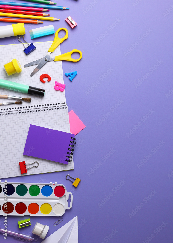 Fototapeta premium Vertical photo format. Back to School Supplies and Stationery on a Vibrant Background for a Fresh Start