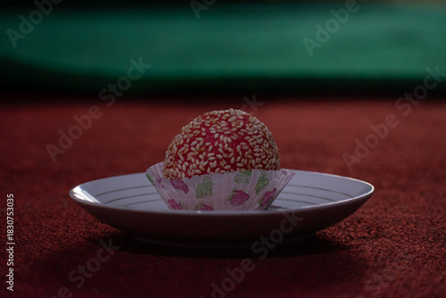Onde-onde is a popular Indonesian sweet snack made of glutinous rice flour balls filled with palm sugar or green bean paste, coated in sesame seeds, and then deep-fried