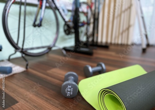 Dumbbells and exercise equipments on floor for workout at home blur background