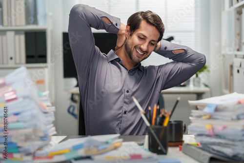 A smiling businessman takes a healthy rest break after he finishes working in the office.