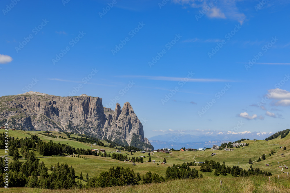 Obraz premium View over the alpine meadows towards the peaks of the Schlern on the Seiser Alm, Dolomites, South Tyrol, Italy.