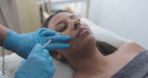 Young woman gets a botox treatment inside private medical clinic - Beauty trends and anti aging concept