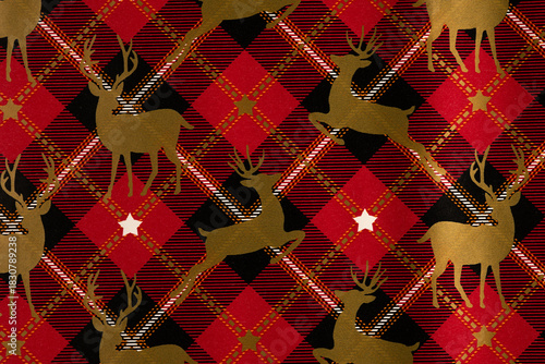 Festive reindeer pattern on red and black plaid background
