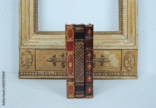 Old antique books with a mirror in the background