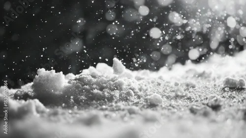 A beautiful winter scene with a ground covered in fresh snow and snowflakes gently floating down from the sky