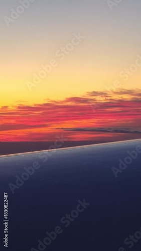 orange sunset dusk clouds sunrise gradient red yellow sky airplane wing view vertical video
