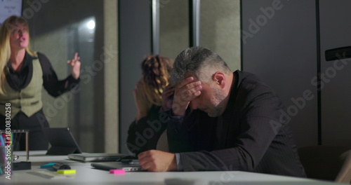 Fotografie Female manager reprimands male employee in front of coworkers during intense off
