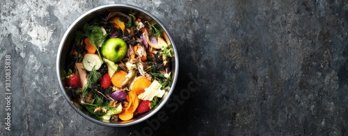 The Bowl of Colorful Fruit and Vegetable Scraps for Composting on Dark Surface