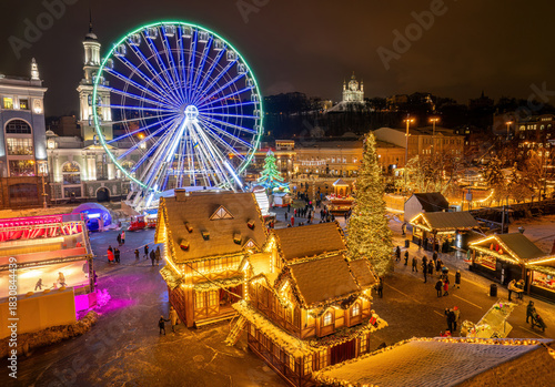 Aerial view of the Christmas market and Ferris wheel in Kyiv, Ukraine at night.