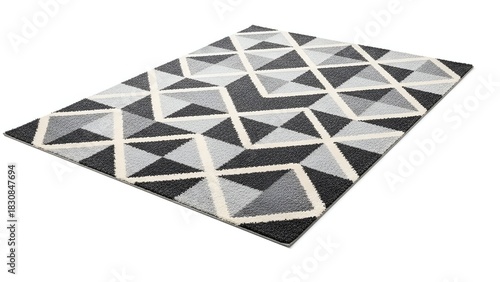 Angled shot of a geometric pattern rug in monochrome shades over a white backdrop