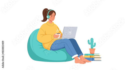 A young woman in headphones and a yellow sweater sitting on a bean bag chair, working on a laptop with a cup of coffee.