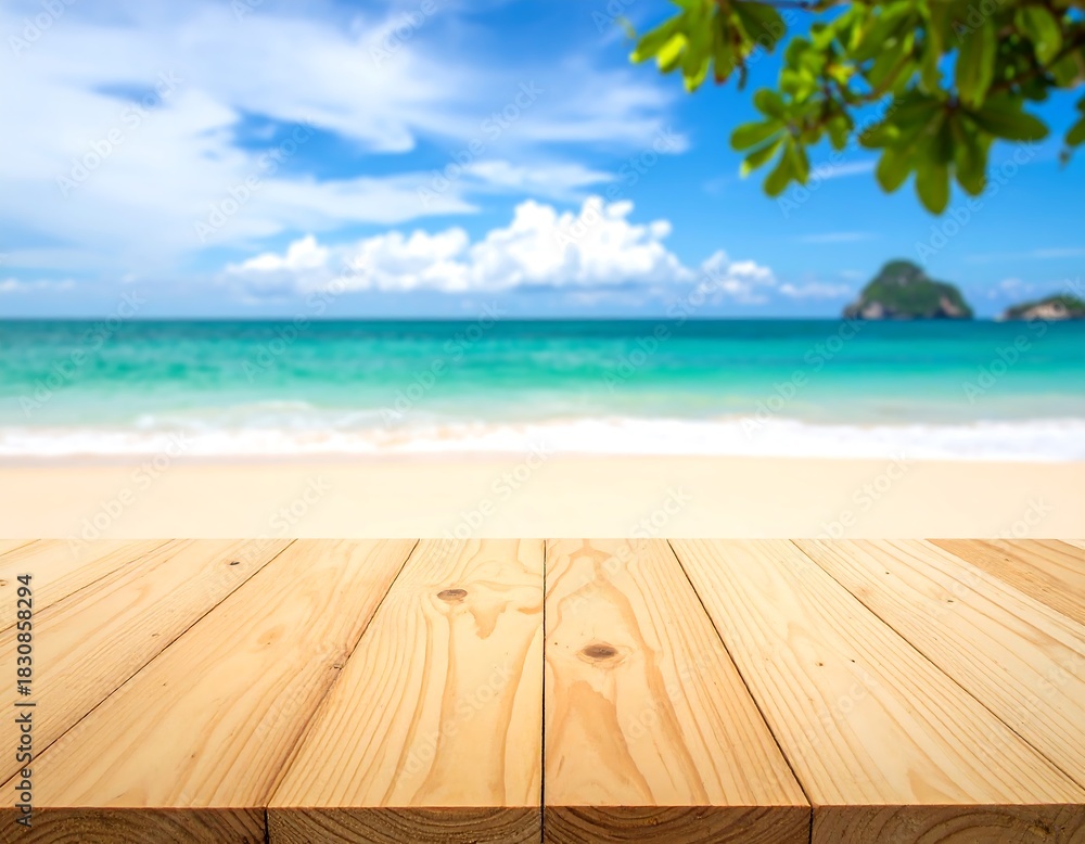 Fototapeta premium Wooden tabletop overlooks a blurred beach with turquoise water, a sunny sky, and greenery overhead