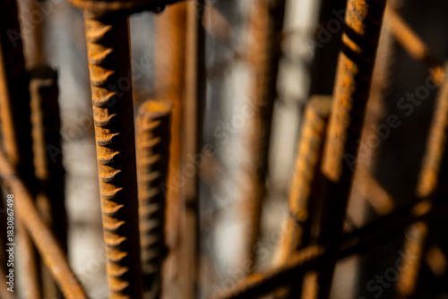 Close-up of rusted steel rebar used in reinforced concrete construction. The image shows the texture and structure of building materials on-site.