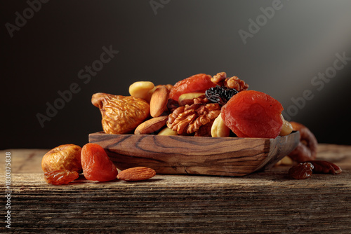 Dried fruits and nuts on a old wooden table.