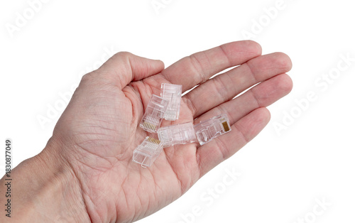Clear RJ45 Ethernet Connectors Held in Palm for Networking and Tech Hardware Imagery isolated on a white background