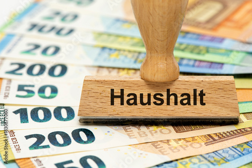 Wallpaper Mural Ein Holzstempel ist beschriftet mit dem Aufdruck Haushalt als Symbolbild für Planung und Konzeption eines Finanzplans für den Haushalt - digital bearbeitet Torontodigital.ca