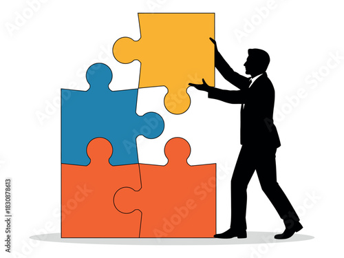 Silhouette of a man placing a yellow puzzle piece on top of other pieces