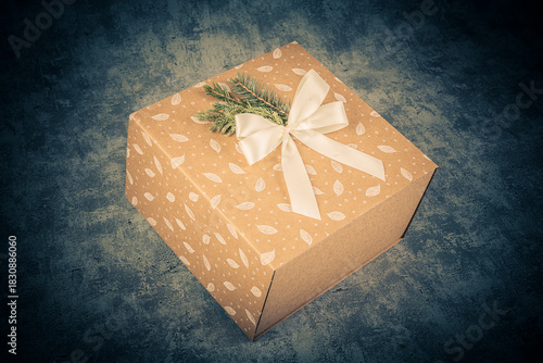 Gift box with bow on grunge background. Toned.