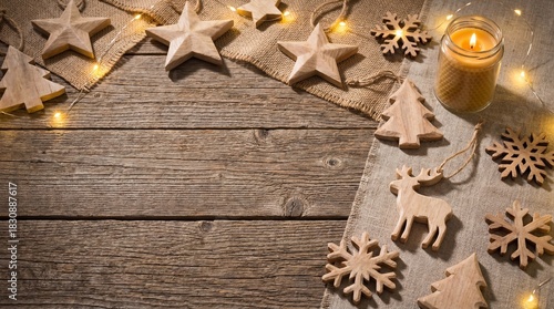 Rustic Wooden Christmas Ornaments and Pine Branches on Vintage Wood Table Background.