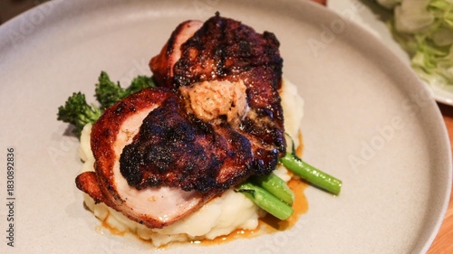 close up of grilled chicken breast with Asparagus on smashed potato with copy space