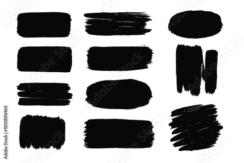 Abstract black paint brush strokes and grunge texture elements set on a white background