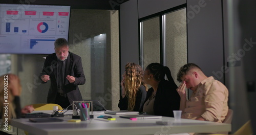 Картината върху платно Frustrated manager holding head in hands during tense office meeting as disheart