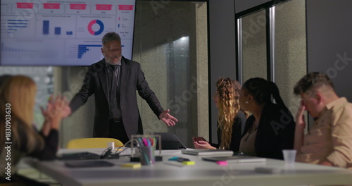 Фотография Frustrated manager holding head in hands during tense office meeting as disheart