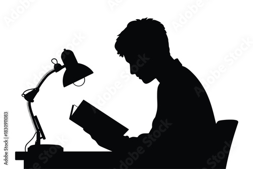 Silhouette of a person reading a book under a lamp